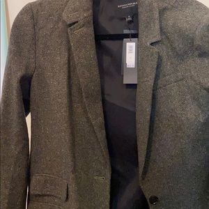 Green blazer with specks. Two front pockets